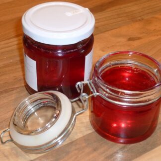 Two jars of blackberry jelly.