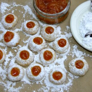 A bunch of Blackberry Cookies being made next to an open jar of jam